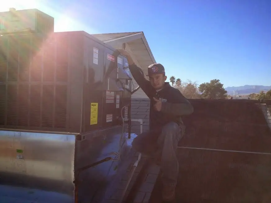 HVAC technician performing Boiler Repair on a rooftop unit in Shenango